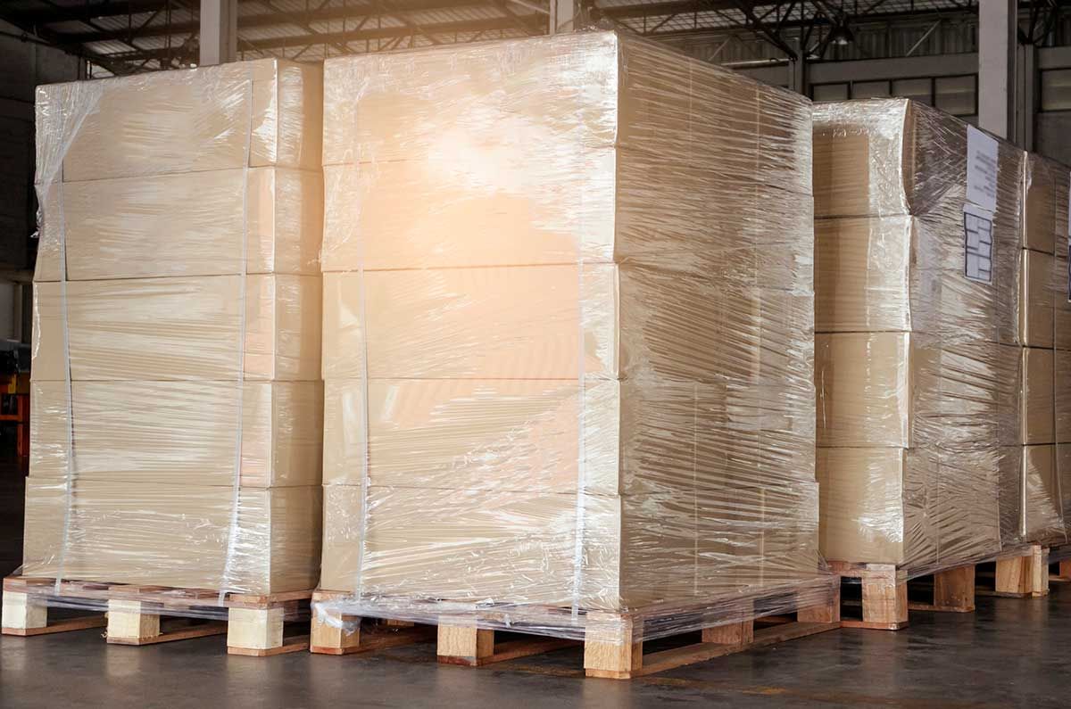 Stacked cargo boxes wrapped in plastic in a warehouse